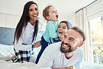 Family, portrait and laughing on bed in house, having fun and bonding together. Comic, love and care of happy father, mother and kids or boys playing, smile and enjoying quality time in home bedroom.