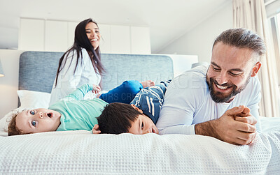 Buy stock photo Happiness, smile and family being playful in the bedroom together of their modern house. Happy, love and excited children having fun, playing and bonding with their parents on the bed at their home.