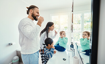 Buy stock photo Happy family, man and kids in bathroom for brushing teeth, healthcare and bonding to start morning in house. Young father, mother and children with toothbrush, smile and mirror for medical self care