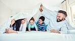 Family, blanket and fun by children and parents in bed, happy and smile while playing and bonding in their home. Bedroom, fort and kids with mother and father, waking up and enjoying weekend indoors