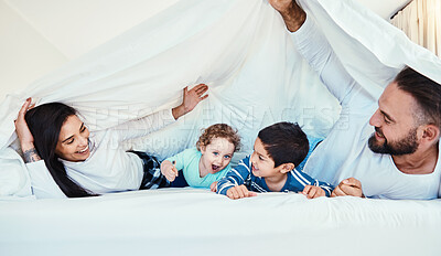 Buy stock photo Love, parents and children with blanket, quality time and bonding together on weekend, break and smile. Family, mother and father with kids, bedroom and happiness with joy, smile or carefree to relax
