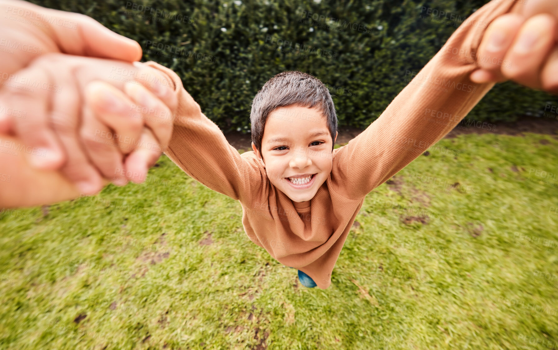 Buy stock photo Playing, happy and portrait of a child swinging with hands from a parent for fun and bonding. Smile, playful and carefree boy kid in a fast swing while holding hands with mom or dad in a garden