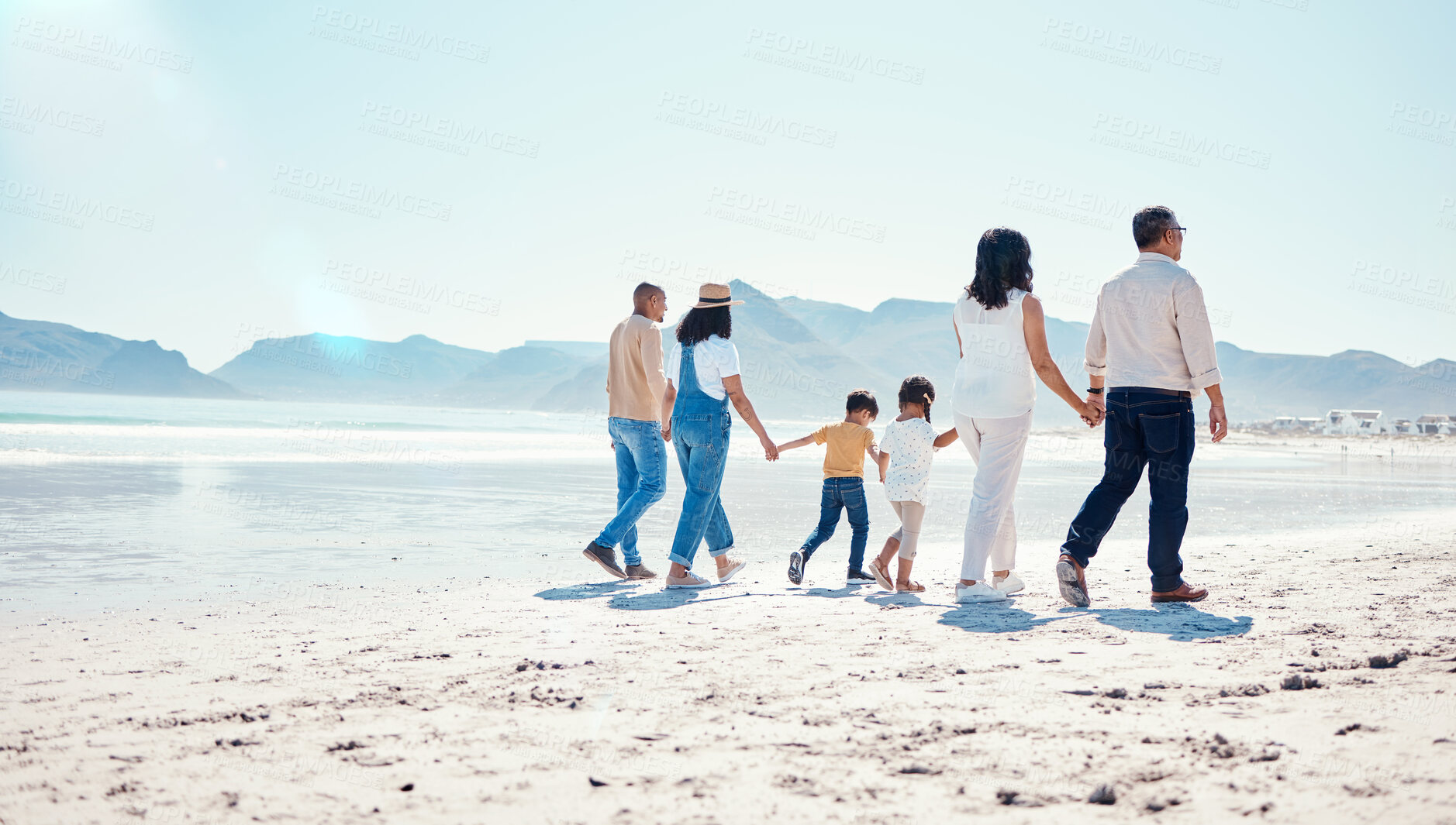 Buy stock photo Beach, love and big family holding hands while walking on a vacation, adventure or weekend trip. Travel, seaside and children on walk with their parents and grandparents by the ocean while on holiday