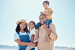 Family piggyback, portrait and smile at beach on vacation, having fun and bonding with mockup. Holiday, relax and care of happy father, mother and kids or children by seashore enjoying time outdoors.