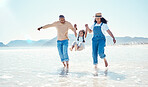 Mother, father and girl in water at beach for bonding, quality time and summer adventure together. Travel, family and happy mom, dad and child enjoy holiday, vacation and relax on weekend by sea