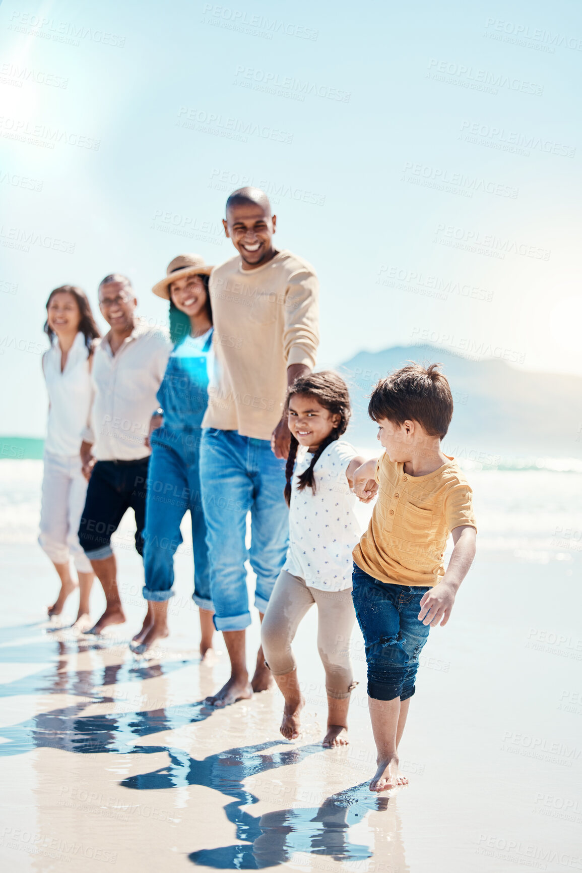 Buy stock photo Walking, portrait and a big family holding hands at the beach for a walk, bonding and playing. Love, carefree and children at the sea with grandparents and parents on a holiday in Spain together