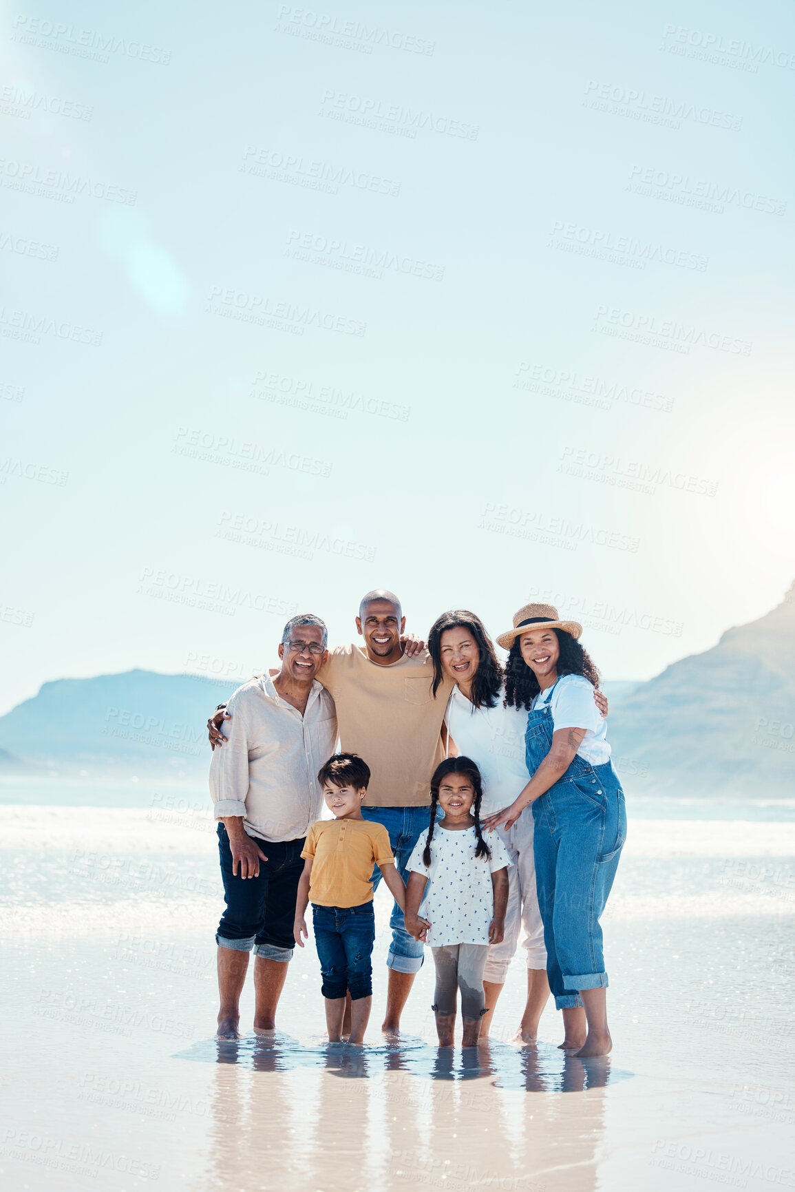 Buy stock photo Family, beach portrait and smile on vacation, bonding and love in summer sunshine by mock up space. Group, men and women with children with happiness, freedom and adventure by sea waves on holiday