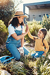 Family, children or high five with a mother and daughter gardening while planting plants together. Nature, kids or landscaping with a woman and female child working in the garden during spring