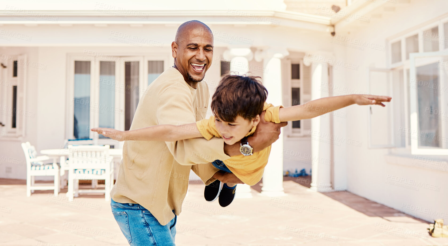 Buy stock photo Playing, flying and smile of a child with a father for freedom, imagination or bonding. Happy, play and carefree dad holding boy kid to pretend to fly, adventure and happiness together at home