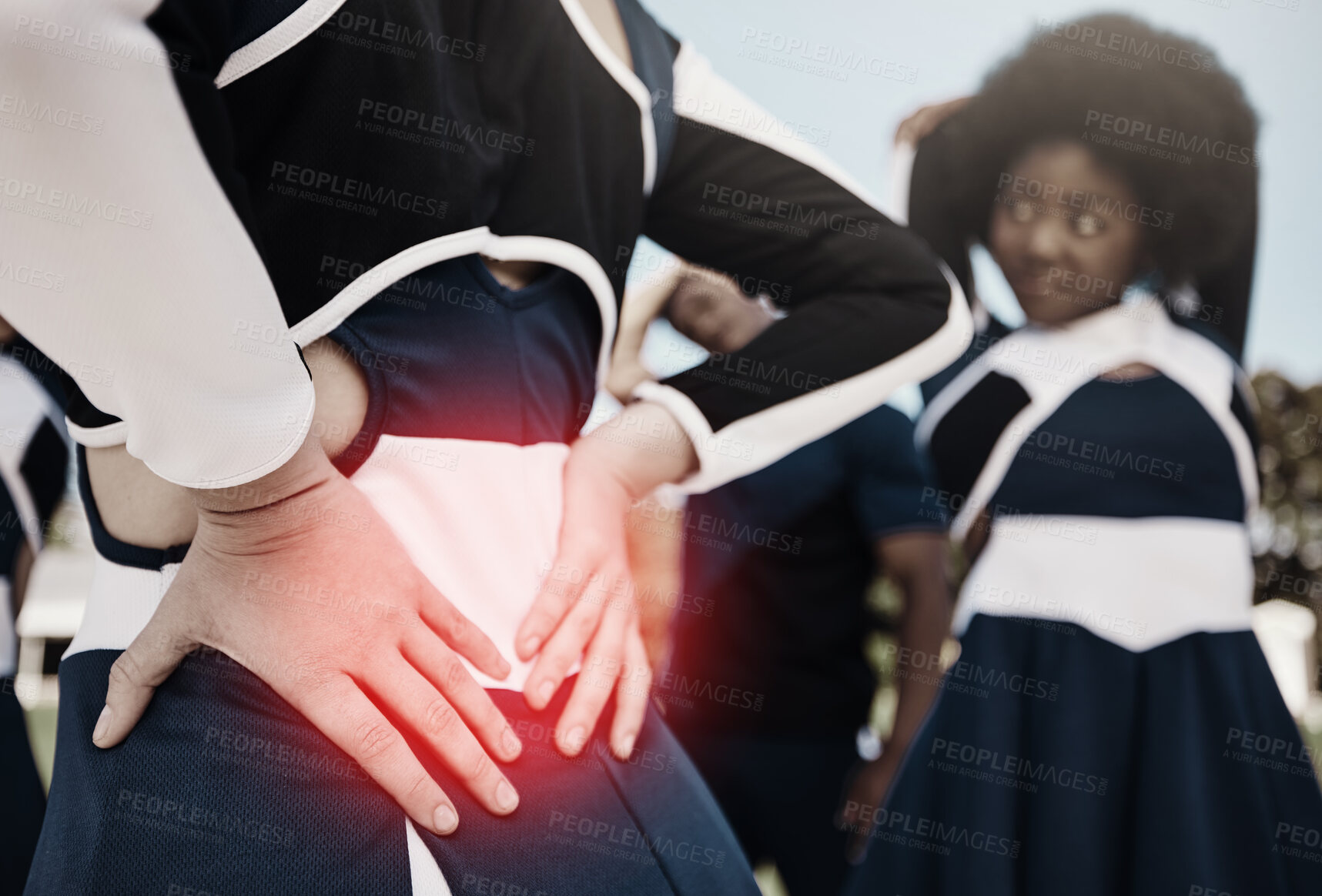 Buy stock photo Cheerleader, sports or woman with back pain, injury or accident on field in game or training match. Red glow, fitness or cheerleading girl athlete with medical emergency, body joint or muscle sprain