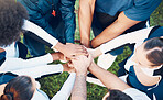 Above, hands and friends in sports huddle for support, collaboration or team building mission. Top view, people and hand connect for teamwork, motivation and cooperation, agreement and training goal