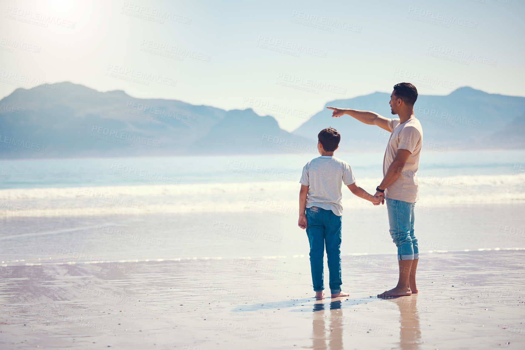 Buy stock photo Hand holding, happy and father with son at beach and pointing for summer break, vacation and travel. Bonding, affectionate and holiday trip with man and boy for relax, care and free time on weekend