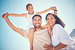 Portrait, beach and happy family smile, piggyback and bond outdoor against blue sky background. Travel, face and girl with parents on an ocean vacation, holiday or trip in Miami, excited and cheerful