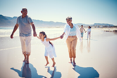 Buy stock photo Beach, holding hands and playing, grandparents with girl, family walking on ocean sand together. Fun, vacation and happy senior man and woman with children bonding, quality time and summer in nature.