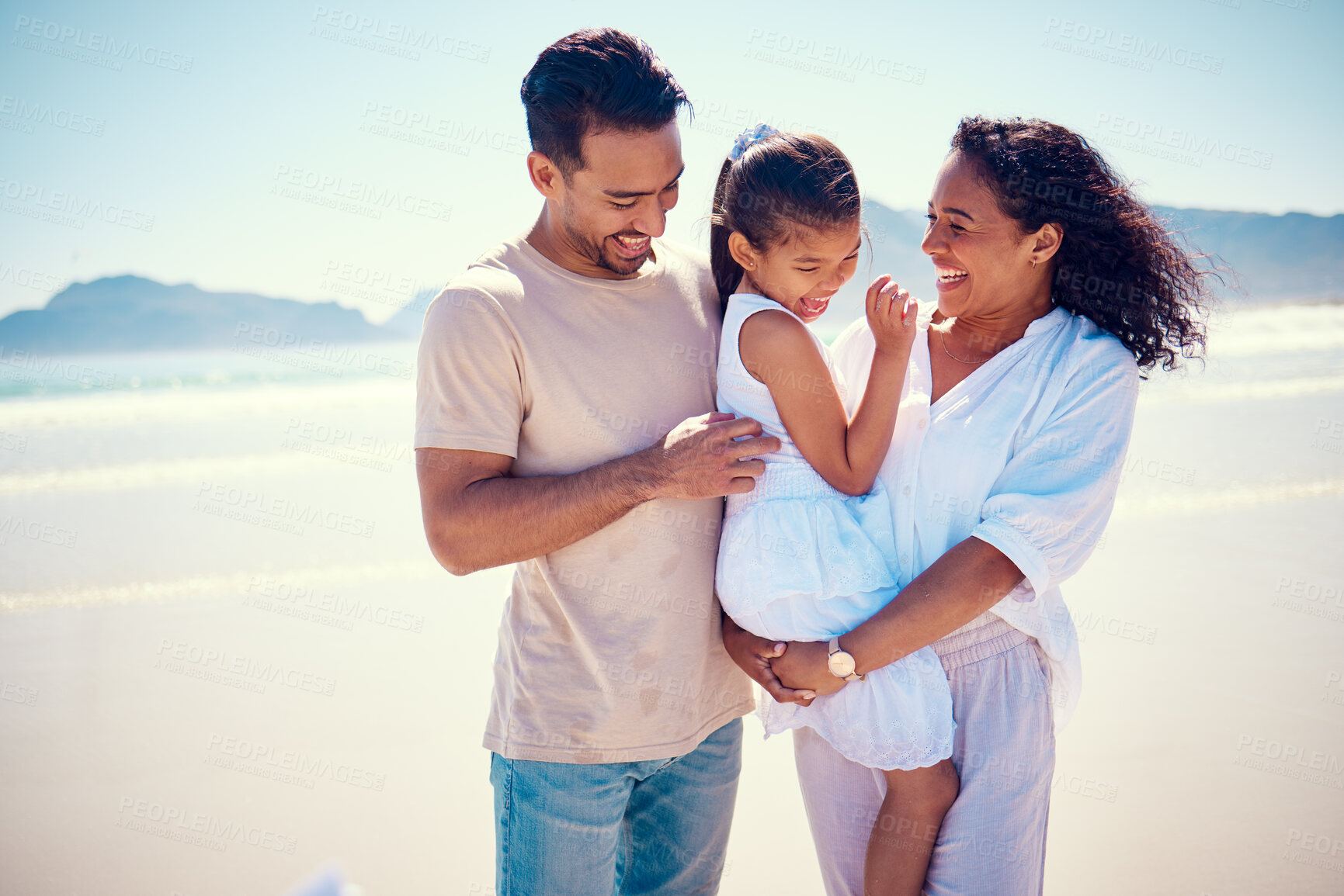 Buy stock photo Happy family, beach smile and playing of a mother, father and girl together by the ocean. Nature, sea and love of a mom, dad and child in Philippines on vacation with parents tickle on travel holiday