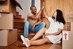 Moving boxes, high five and black woman and man together in new real estate and property. Couple, family and young people in a apartment with packing up box with motivation and teamwork in a home