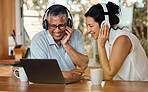 Headphones, laptop and senior couple on video call in home, chatting and talking to contact. Technology, computer and happy, elderly and retired man and woman laughing in funny in online conversation