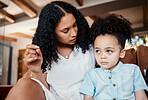 Comfort, support and mother with crying child sitting on floor in living room and talking after tantrum. Anxiety, security and trust, woman comforting sad boy with love and safety from mom at home.