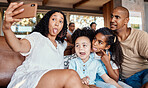 Family, funny face and selfie with tongue out in home, having fun and bonding together. Interracial, comic photographer and father, mother and girls taking pictures for social media and happy memory.