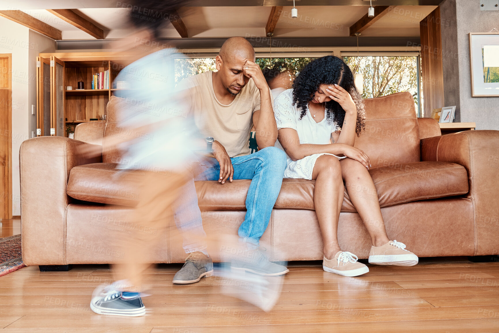 Buy stock photo Kids running, stress and parents on sofa tired and chaos in living room with frustrated mom and dad with parenting burnout. Excited children, energy and playing in home with woman and man in crisis.