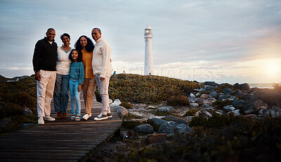 Buy stock photo Big family, portrait walking and nature bonding on a holiday at sunset by a sea lighthouse. Ocean, beach walk and outdoor with a mom, father and child together with love and parents support at dusk