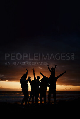Buy stock photo Carefree, sunset and silhouette of friends at the beach while on a summer vacation, adventure or weekend trip. Freedom, happy and shadow of group of people having fun together by the ocean on holiday
