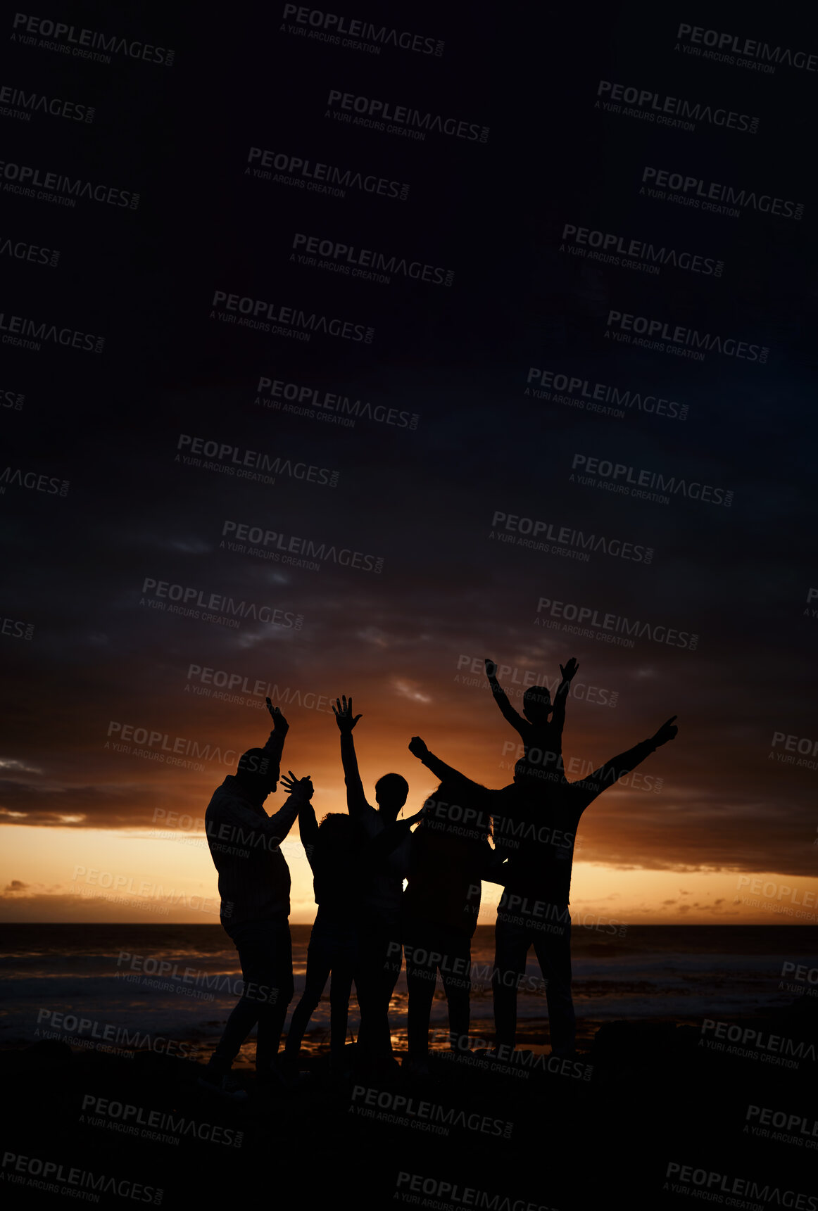 Buy stock photo Carefree, sunset and silhouette of friends at the beach while on a summer vacation, adventure or weekend trip. Freedom, happy and shadow of group of people having fun together by the ocean on holiday