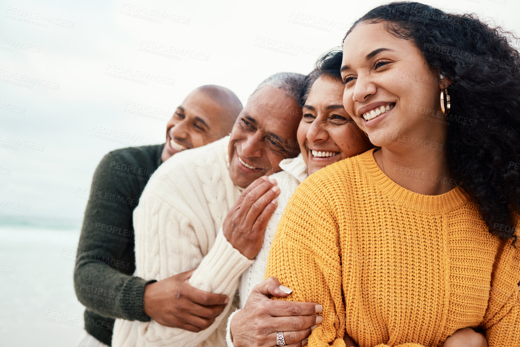 Buy stock photo Love, happy family and hug at a beach by siblings with mature parents on holiday, smile and bonding. Hugging, care and affection by senior couple on retirement vacation while embracing adult children