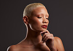 Skincare, makeup and face of black woman, eyes closed and dark studio with platinum hair. Art aesthetic, cosmetics and beauty, African model isolated on grey background with glowing spa skin facial.