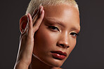 Beauty, makeup and lipstick, portrait of black woman in dark studio with platinum hair isolated on grey background. Art aesthetic, cosmetics and African model with hand on face and luxury spa facial.