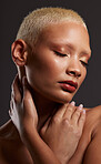Face of black woman, dark studio and makeup, platinum hair and beauty isolated on grey background. Skincare, art aesthetic and cosmetics, and beautiful African model in skin glow and edgy spa facial.