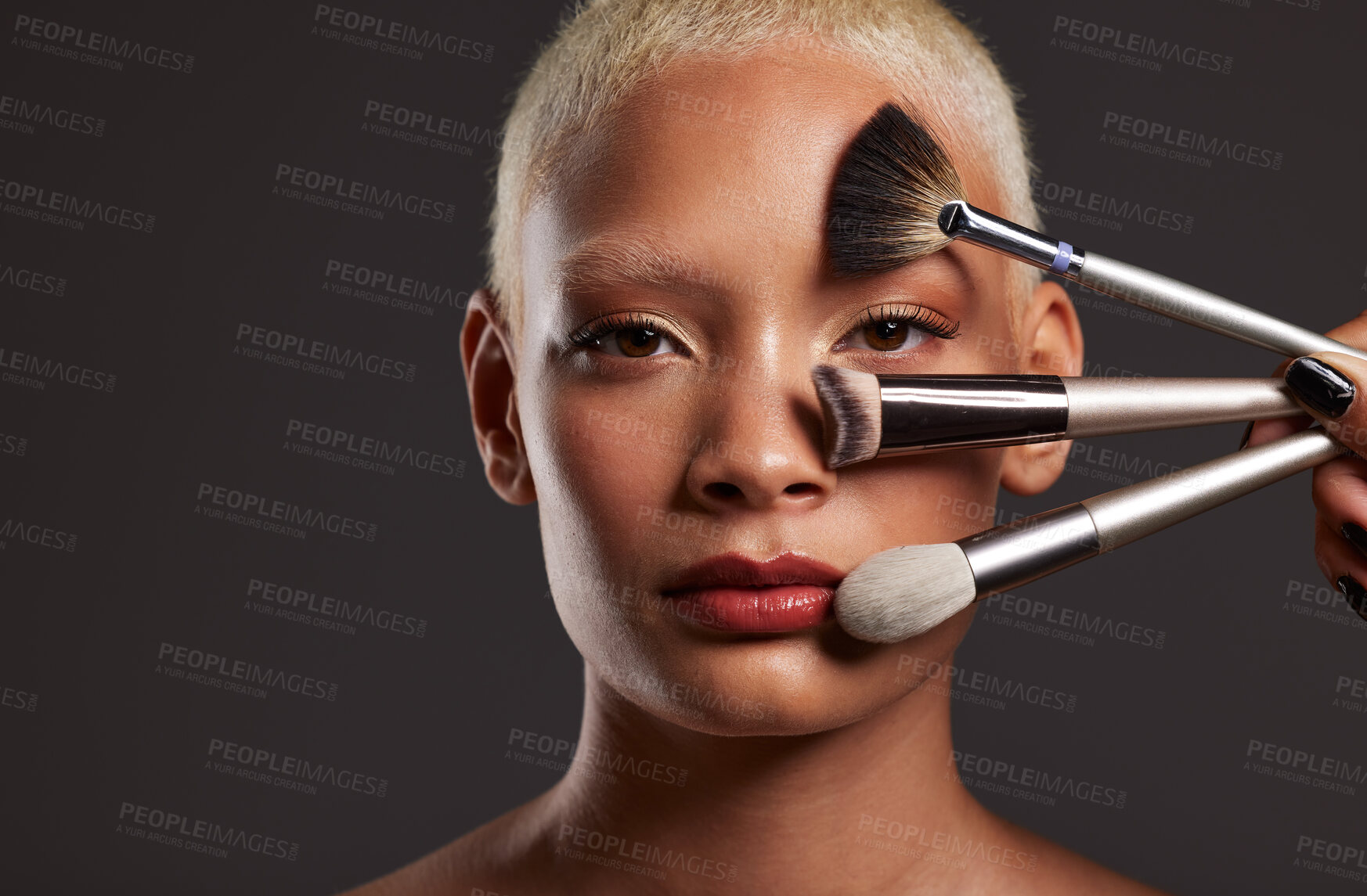 Buy stock photo Woman, portrait and makeup brushes for beauty cosmetics, skincare or facial treatment against a gray studio background. Beautiful female holding cosmetic brushing tools on face for self care or love