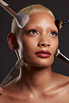 Woman, face and beauty with makeup brushes for skincare cosmetics or treatment against a gray studio background. Beautiful female model with cosmetic brushing tools for facial, self care or love