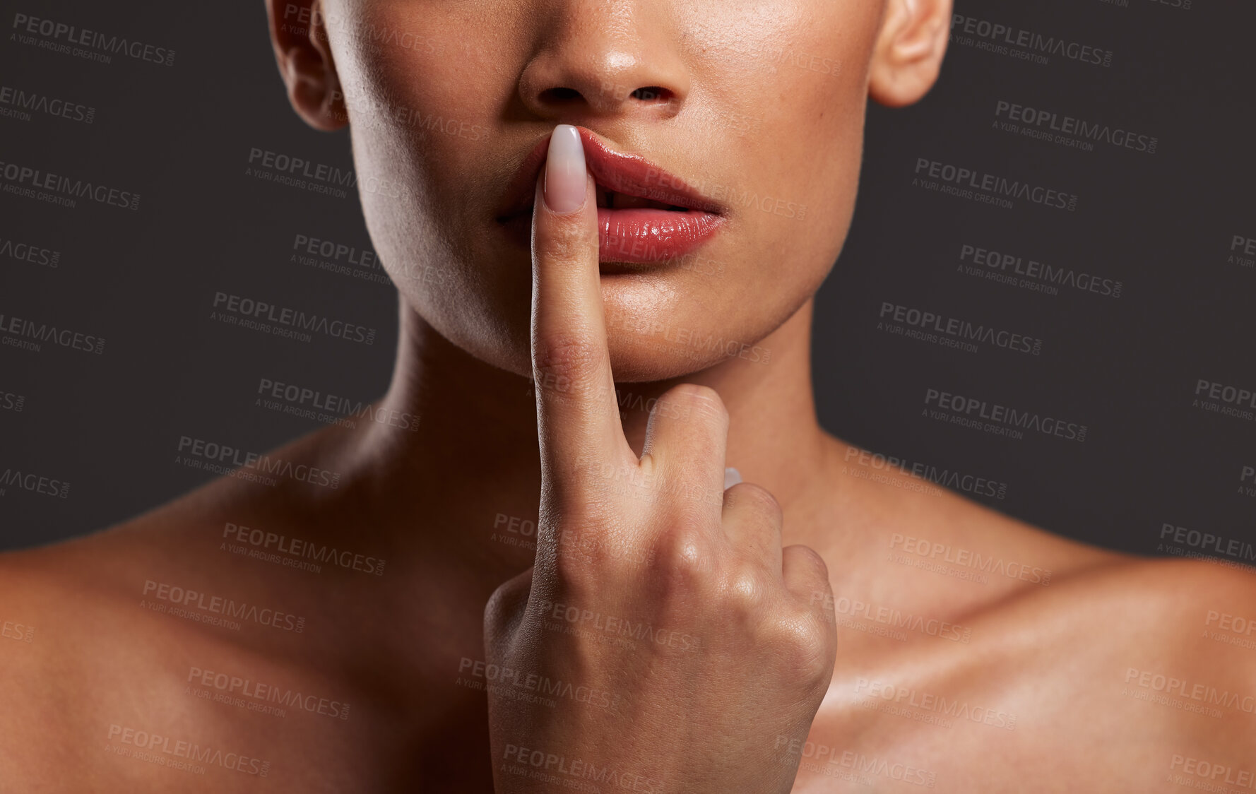 Buy stock photo Finger, lips and beauty with a model woman in studio on a gray background for skincare or cosmetics. Hand, makeup and mouth with a female touching her lip to promote a lipstick or cosmetic product