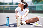 Tennis, warm up and leg stretching by black woman at court for sports, fitness and training on blurred background. Exercise, preparation and foot stretch by athletic girl player on floor before match