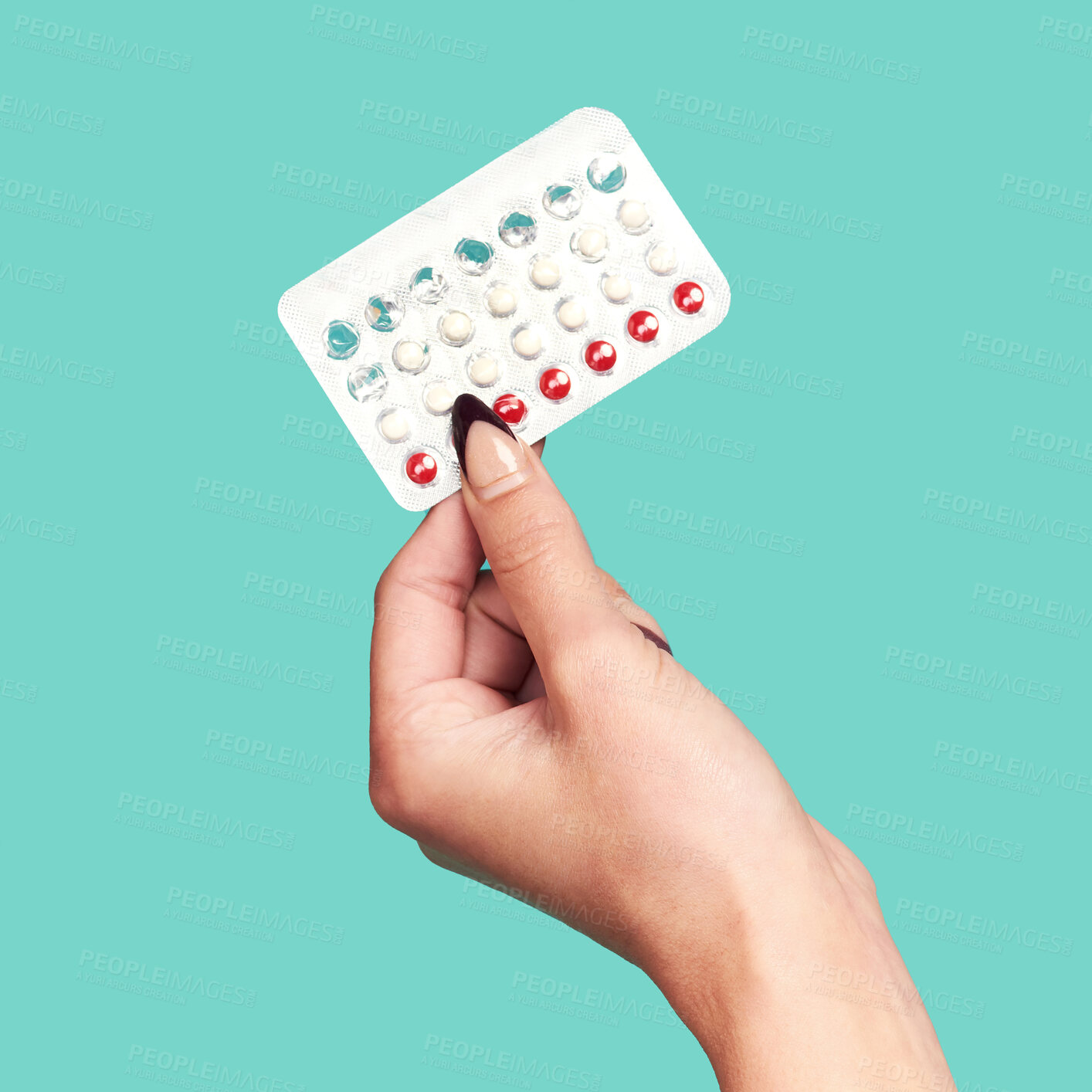 Buy stock photo Woman hands, tablets and medication for birth control on mockup against a studio background. Hand of female holding contraception, healthcare product or medical prescription for market advertising