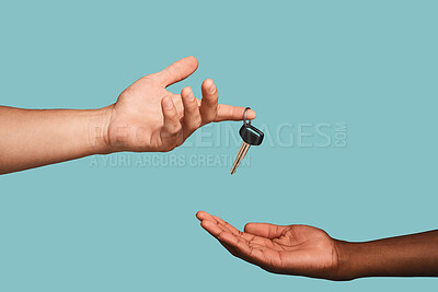 Buy stock photo Hands, key or car dealership with a salesman and customer in studio on a blue background for purchase. Transport, vehicle and deal with an automobile dealer handing keys to a consumer after a sale