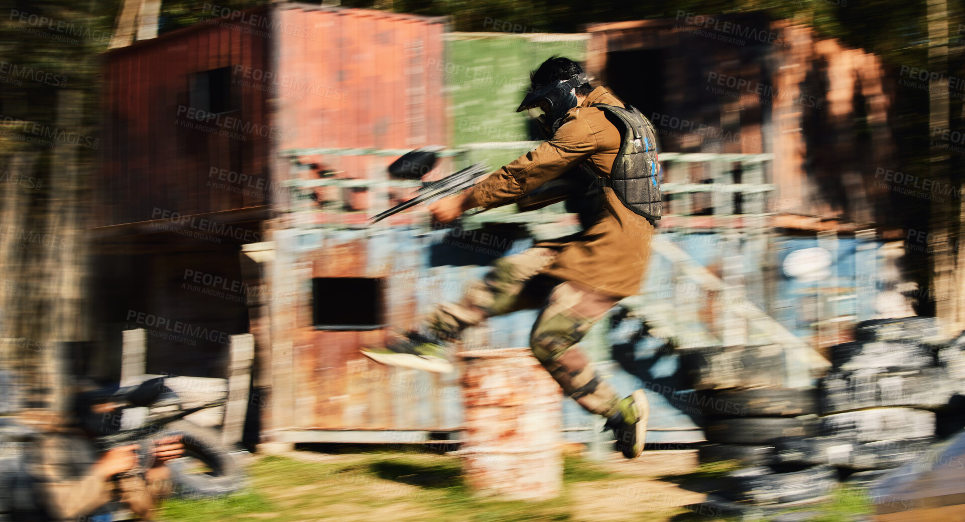 Buy stock photo Paintball, man jump and aim gun at target, military tactics at shooting range and war game for sports outdoor. Soldier with weapon on battlefield, action and camouflage, motion blur and adventure