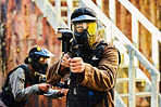 Paintball, person shot with paint and gun, helmet for safety on shooting range and war game for sports. Soldier with weapon on battlefield, action and camouflage uniform with adventure and target
