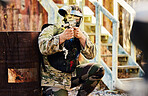 Paintball, military or man with gun in shooting game playing with on fun battlefield mission. Target, warrior or focused soldier with army weapons gear for survival in outdoor challenge competition