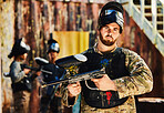 Paintball, serious or portrait of man with gun in shooting game playing in action battlefield mission. War, hero or focused soldier with army weapons gear in survival military challenge competition