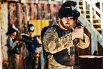 Paintball, target or portrait of man with gun in shooting game playing in action battlefield mission. War, hero or focused soldier with army weapons gear in survival military challenge competition