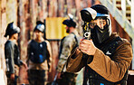 Paintball, focus or portrait of man with gun in shooting game playing in action battlefield mission. War, hero or focused soldier with army weapons gear in survival military challenge competition