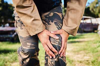 Buy stock photo Hands, soldier and knee injury in paintball sport, running or military training from intense battle or war on grass field. Hand of sports army player holding painful leg ache, accident or bone