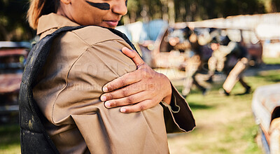 Buy stock photo Hands, soldier and arm injury in paintball sport, running or military training from intense battle or war on grass field. Hand of sports army woman holding painful shoulder ache, accident or wound