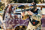 Target, shooting and paintball man with gun for outdoor battlefield, playground or games in grunge adventure training. Aim skill of male player or sports person in military focus and survival mission