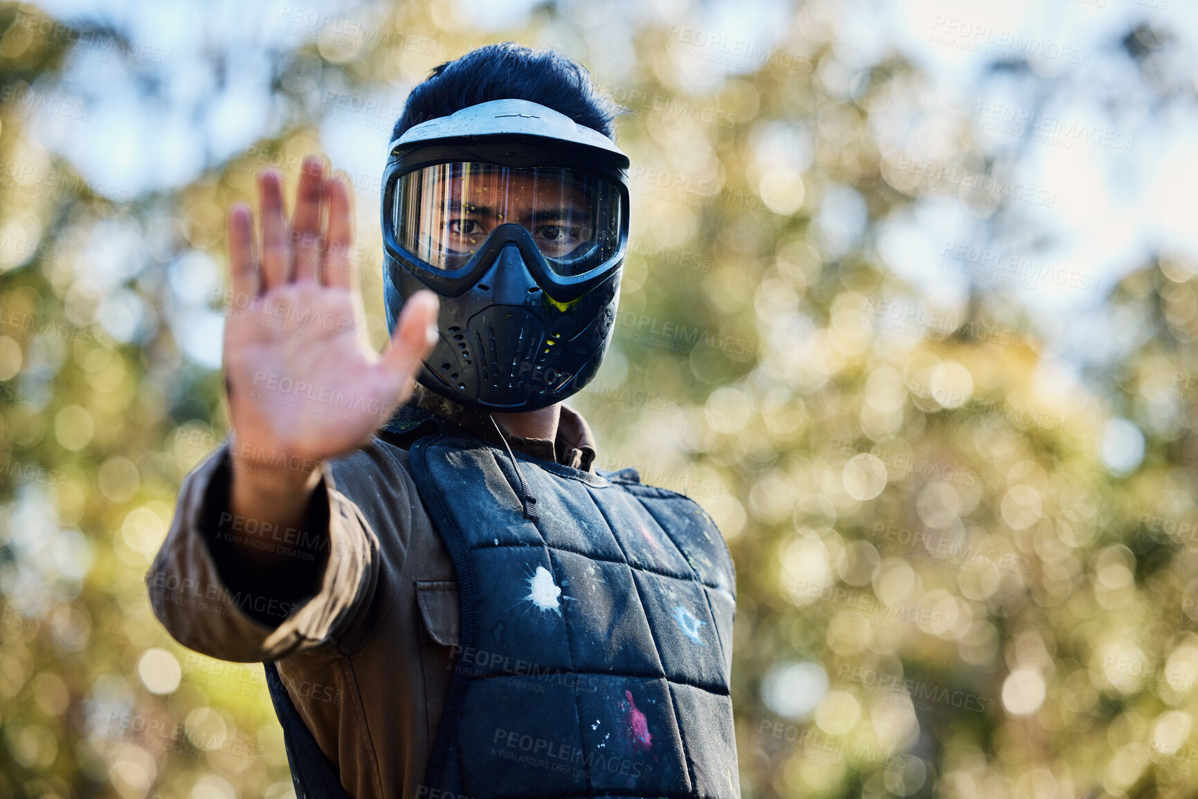 Buy stock photo Man, paintball and hands in stop signal for team communication or strategy on the battlefield in nature. Male paintballer or soldier showing hand sign halt or wait in adrenaline sport outdoors