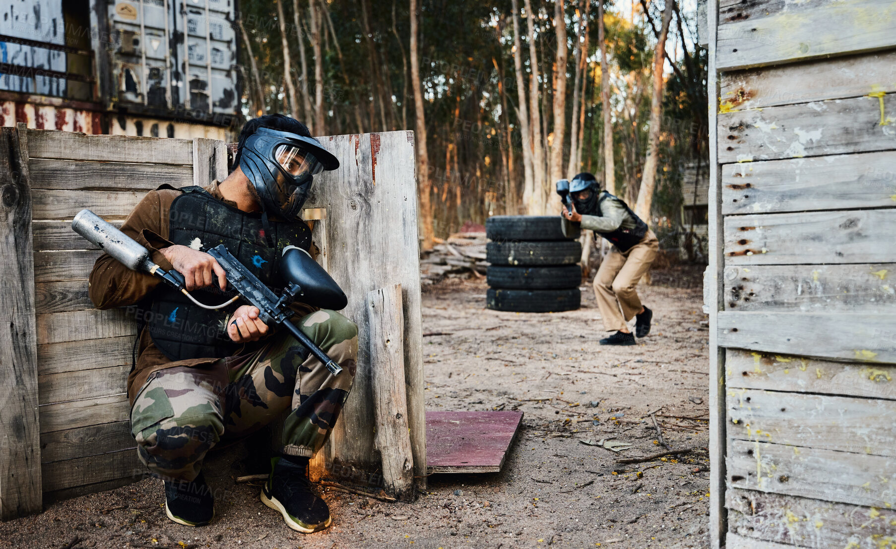 Buy stock photo Sports, paintball and man with gun for battle, game or competition outdoors on field. War, military camouflage and male soldier with weapon on shooting range to hide from player in exercise fight.