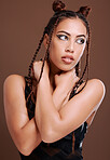 Makeup, fashion and black woman in studio with gen z aesthetic, punk and rocker on brown background. Grunge, edgy and cool girl posing, creative and confident with contemporary, style and attitude
