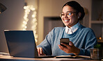 Woman, phone and student with laptop in home for web browsing, project or studying at night. Bokeh, mobile and smile of happy business female, freelancer or remote worker with computer for research.